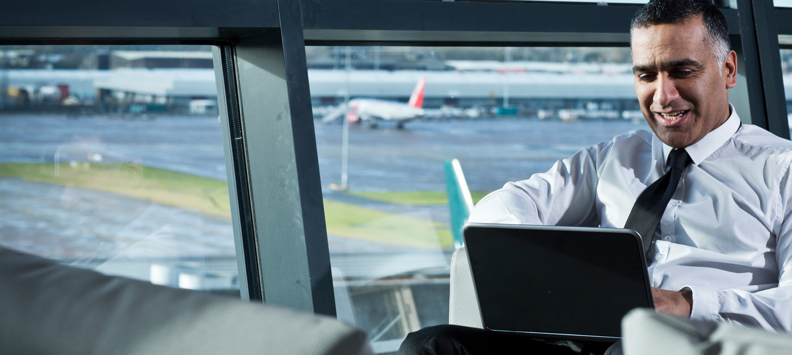 Man using his laptop at an airport