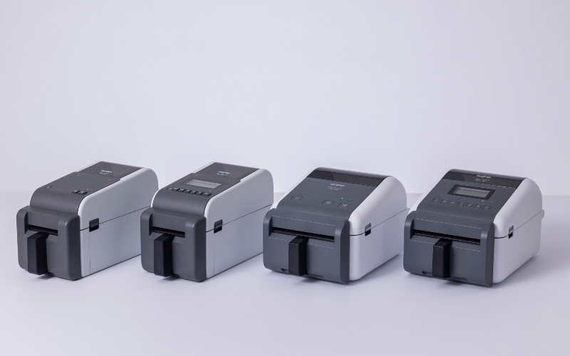 Four grey and black Brother linerless printers side by side