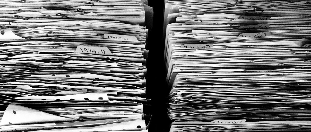 a black and white image of two stacks of paper filling up both sides of the image