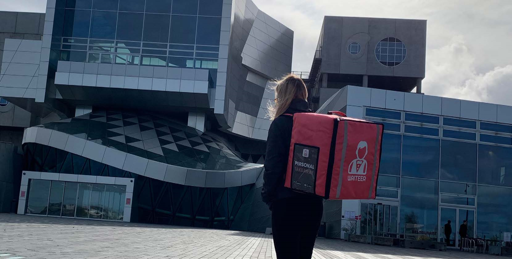 Woman with a Waiteer bag in front of a building