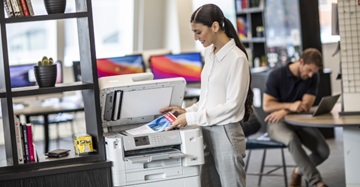 woman standing next to Brother device